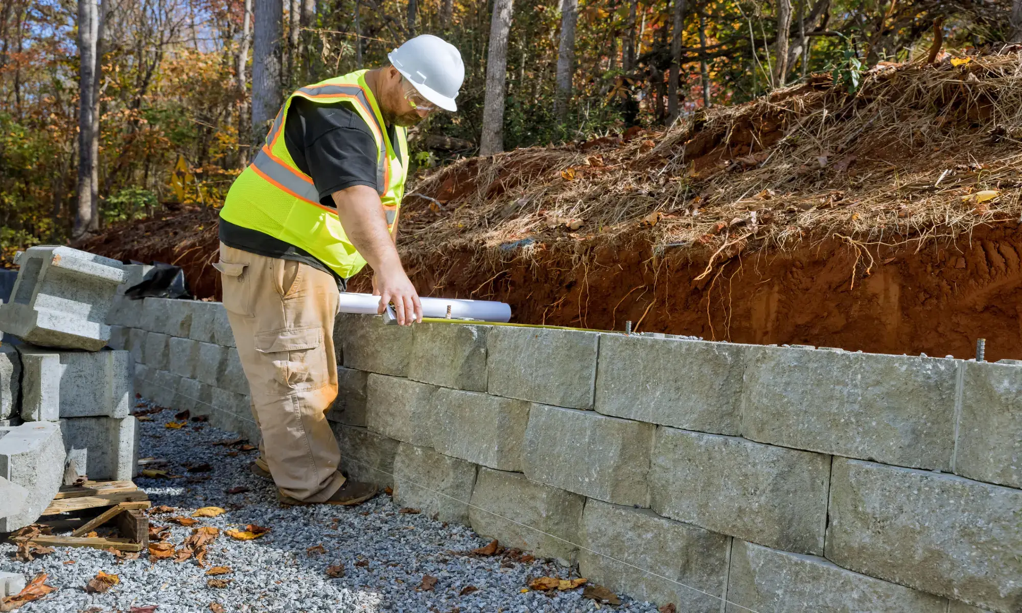 Worker building a stone retaining wall.