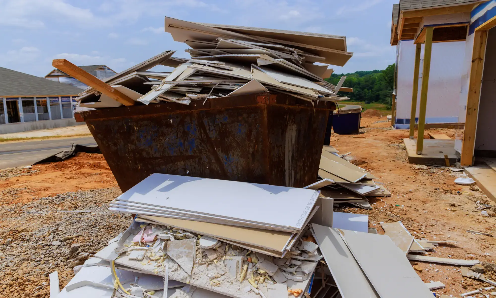 Construction debris piled in a large dumpster.