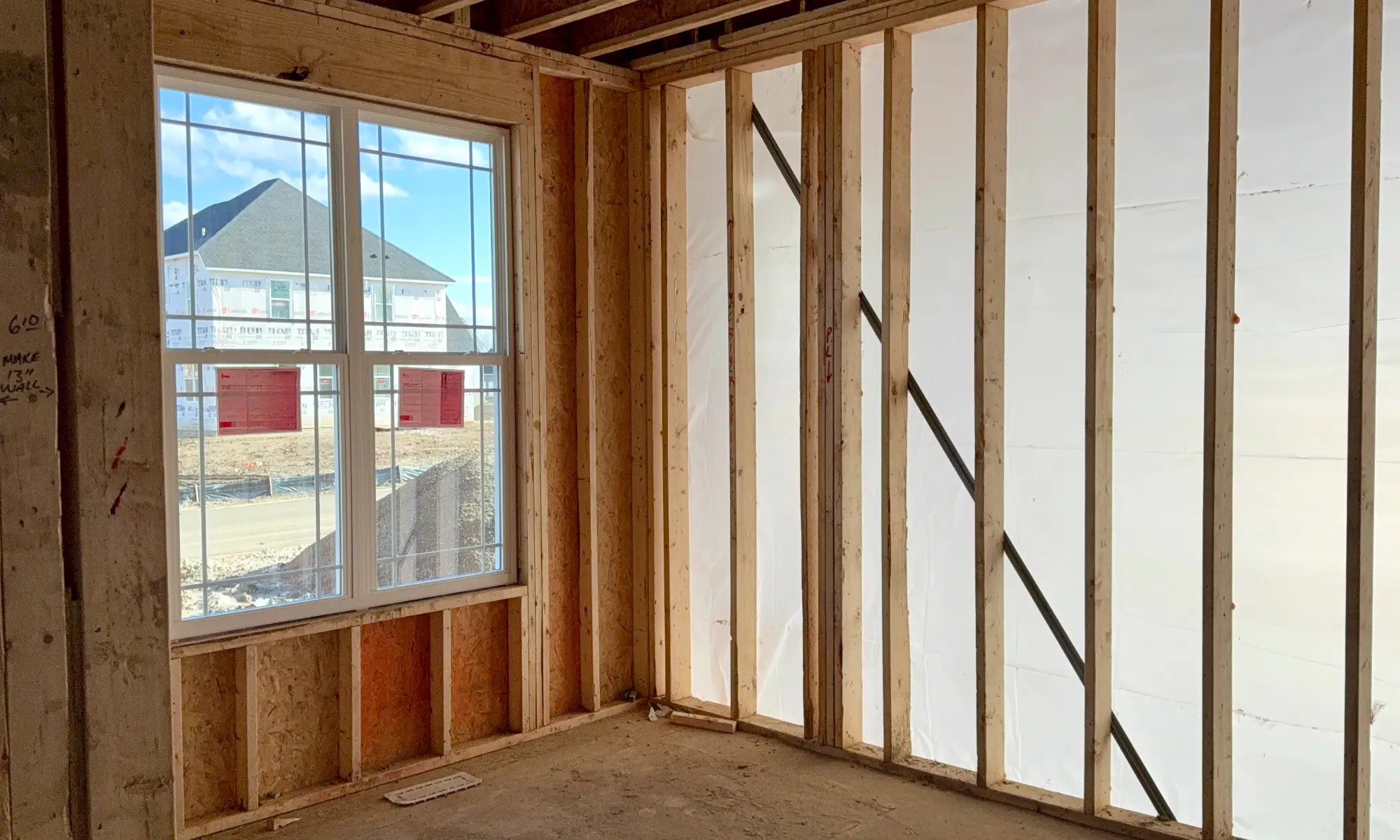 House under construction with exposed wooden framing.