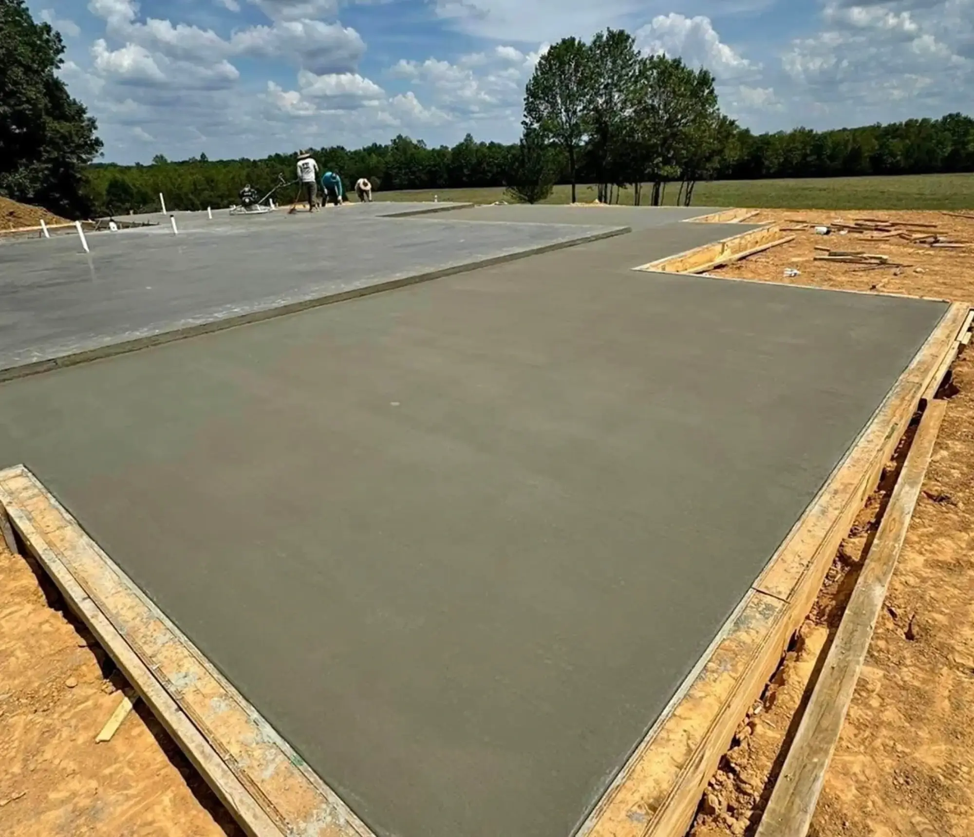 Freshly poured concrete slab drying outdoors on a sunny day.