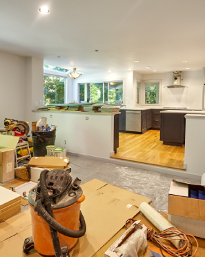 Room under renovation with tools and wood flooring visible.